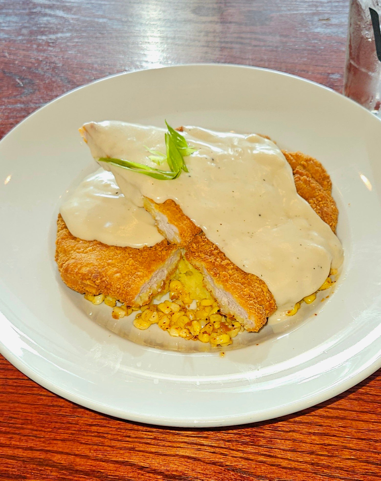 Mashed Potatoes, gravy, street corn, & Fried Pork Tenderloin dinner in Coralville at the restaurant Vesta
